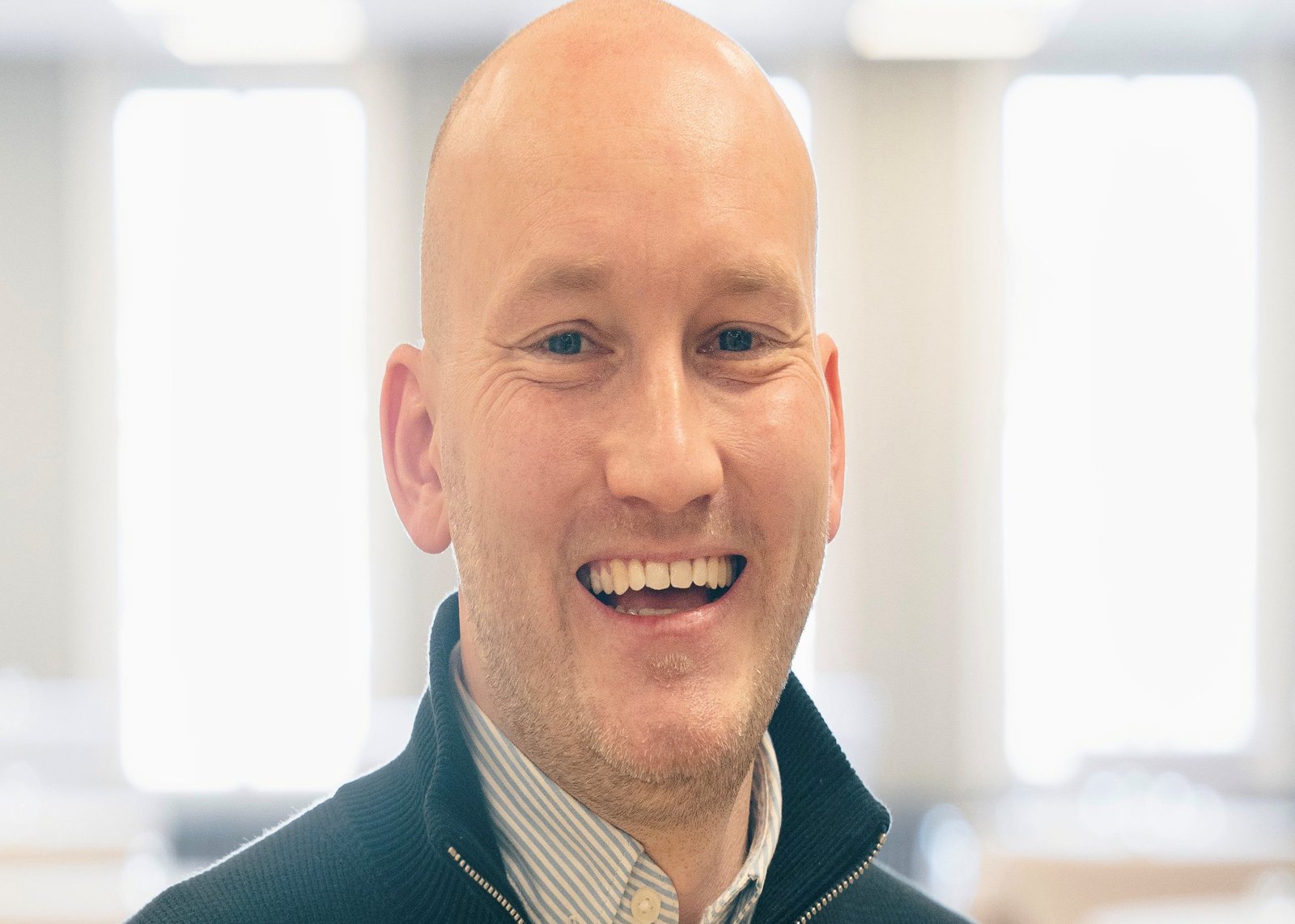 A man smiles at the camera